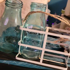 HANDMADE DAIRY BOTTLES SITTING IN A METAL HANDLE HELD CONTAINER